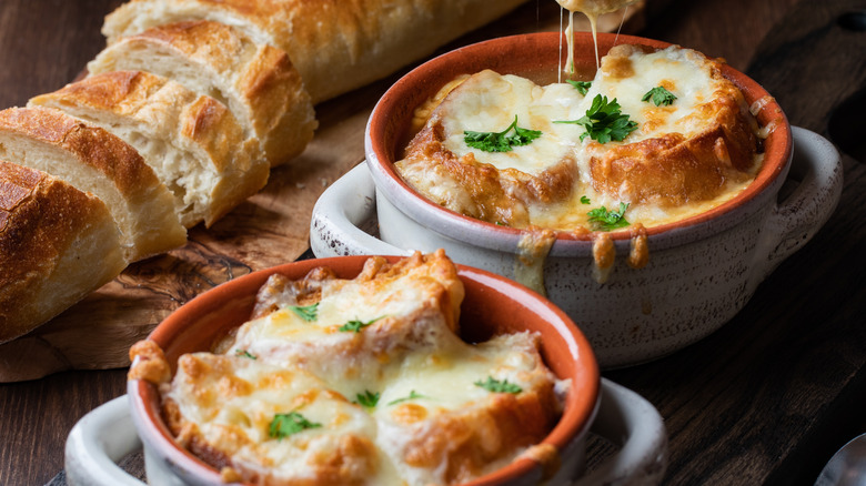 cut bread with two bowls of French onion soup