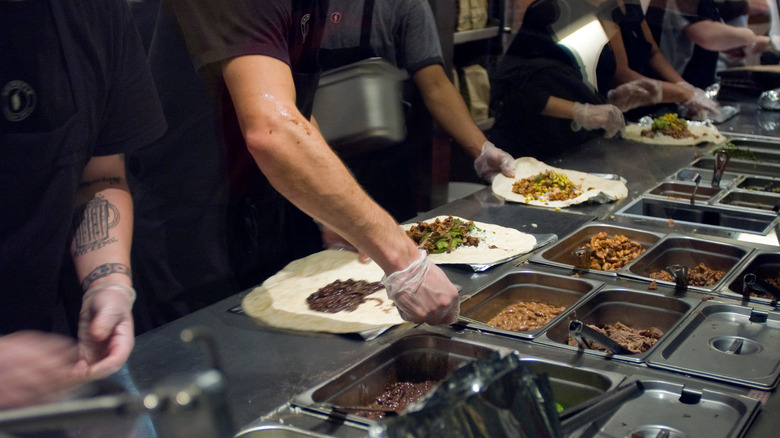 Chipotle workers making burritos