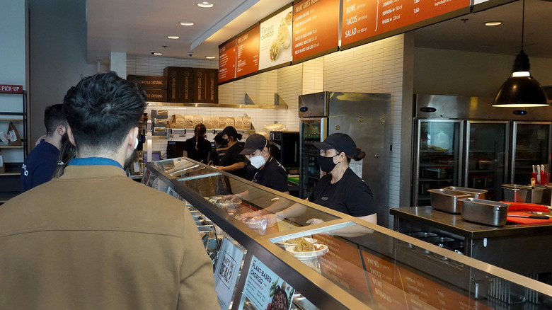 Chipotle workers preparing food