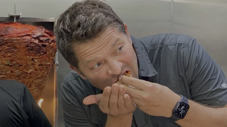 Misha Collins eating food from hands