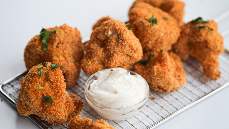 roasted breaded cauliflower on rack with dip