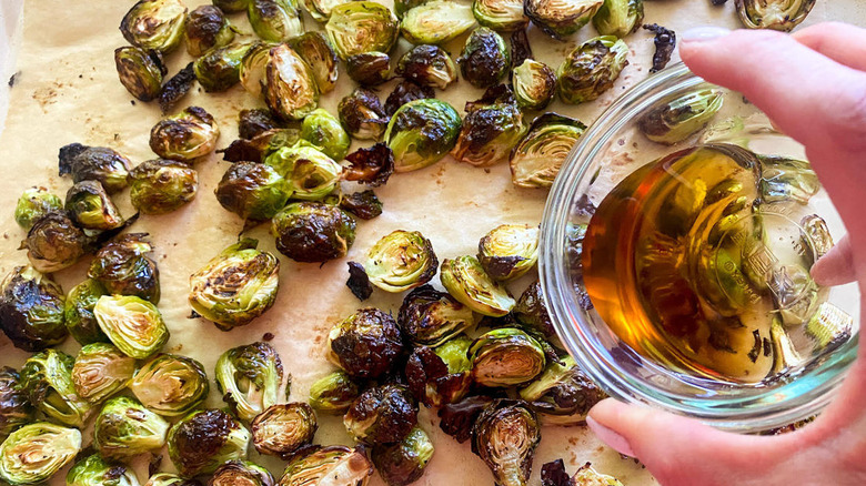 pouring syrup onto Brussels sprouts