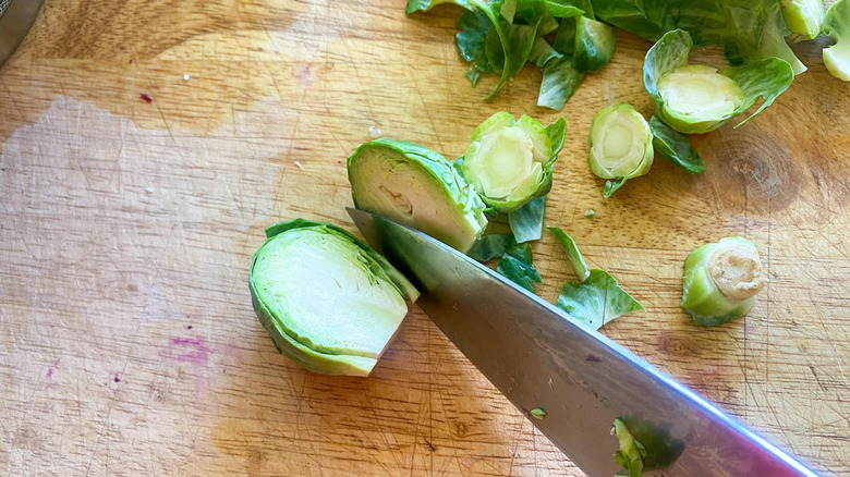 knife cutting through Brussels sprout