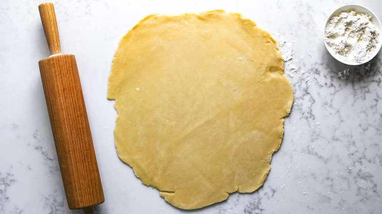 pie dough next to rolling pin