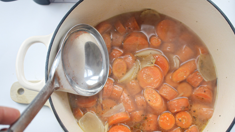 cooked broth with carrots and onion for roasted carrot soup