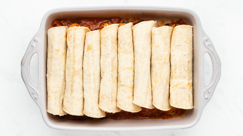 Rolled tortillas in baking dish