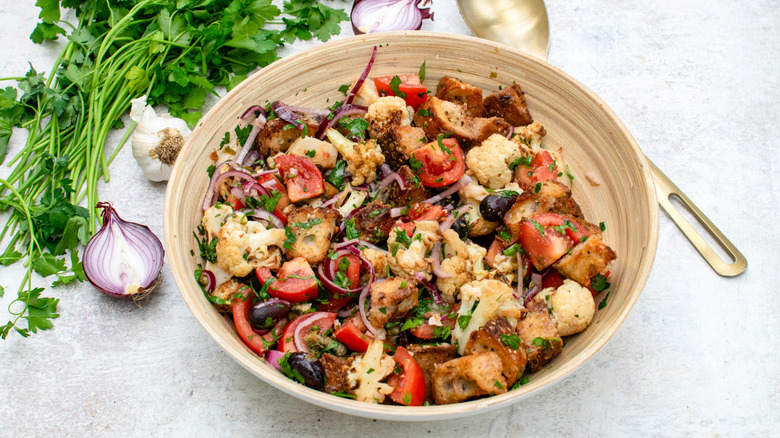 roasted cauliflower panzanella salad with spoon