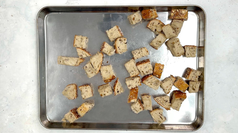 bread cubes on baking sheet