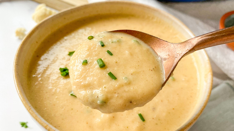 A bowl and full spoon of soup