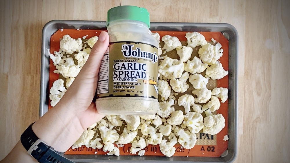 roasted cauliflower being seasoned