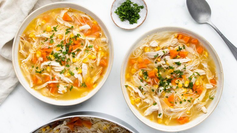 Corn and chicken noodle soup in bowls