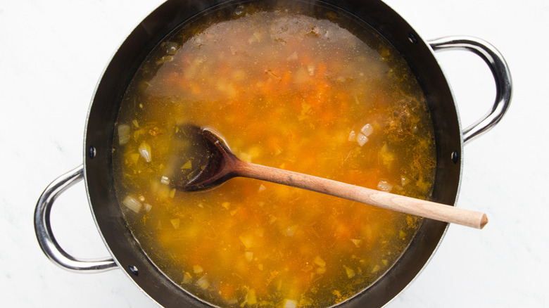 Chicken broth and veg in soup pot