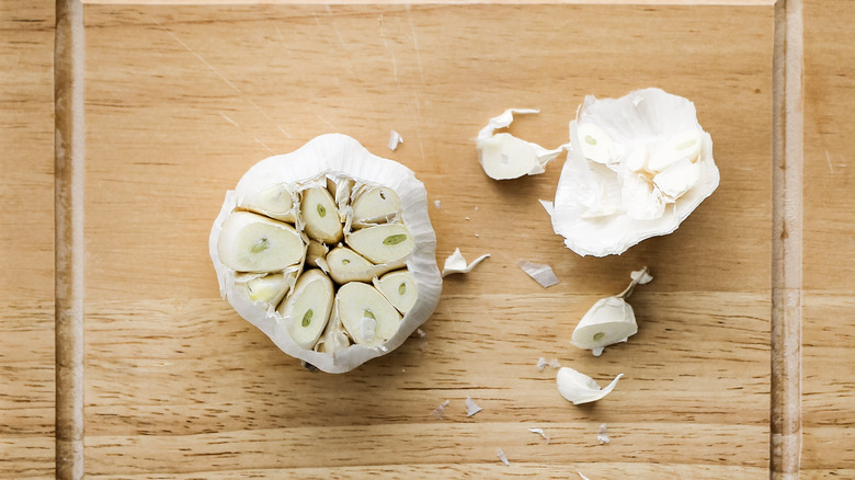 garlic head on cutting board