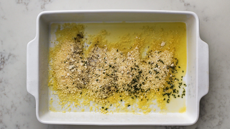 seasoning with butter in baking dish