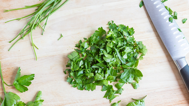 chopping parsley on a cutting board