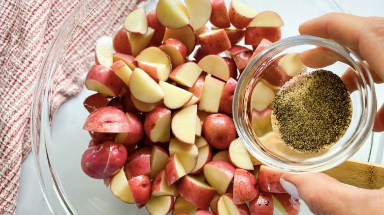 seasoning poured over red potatoes