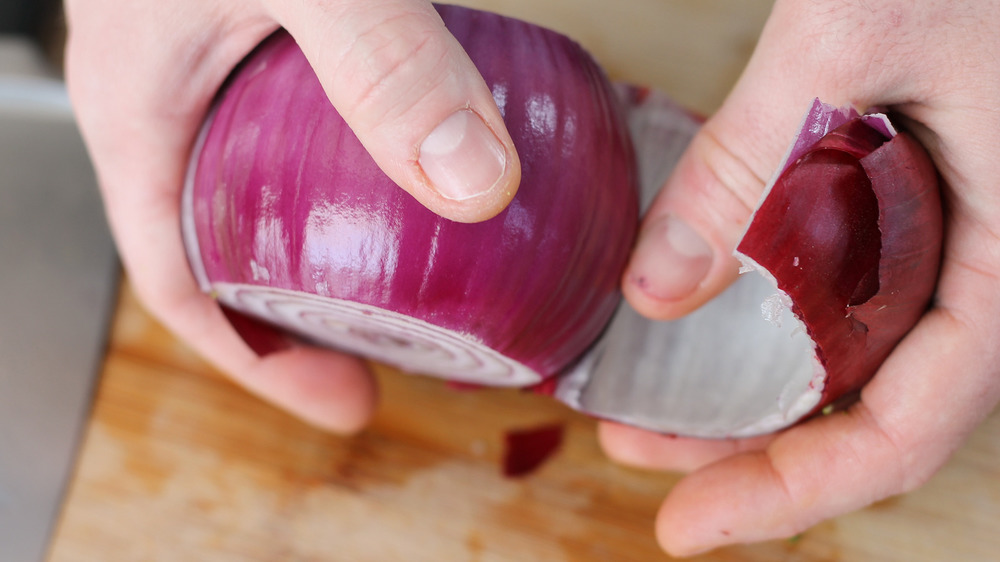 peeling a red onion