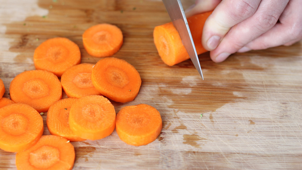 slicing carrots with knife for roasted vegetables