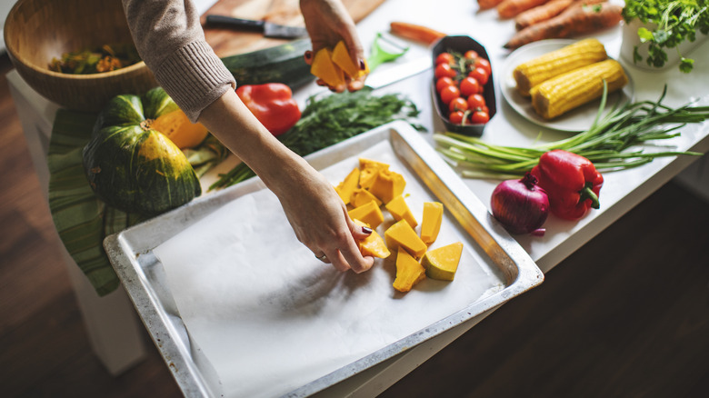 Placing vegetables on baking tray