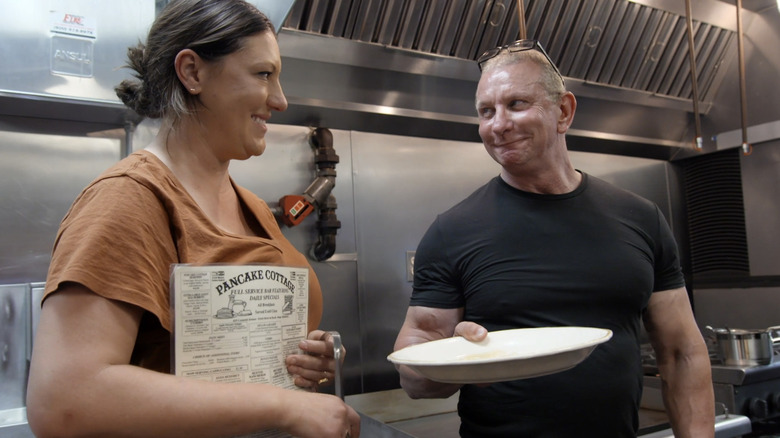 Robert Irvine smiling in kitchen