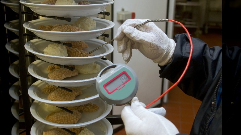 Food inspection on paper plates of fried chicken