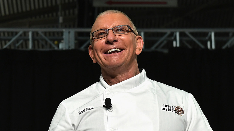 Robert Irvine cooking on stage