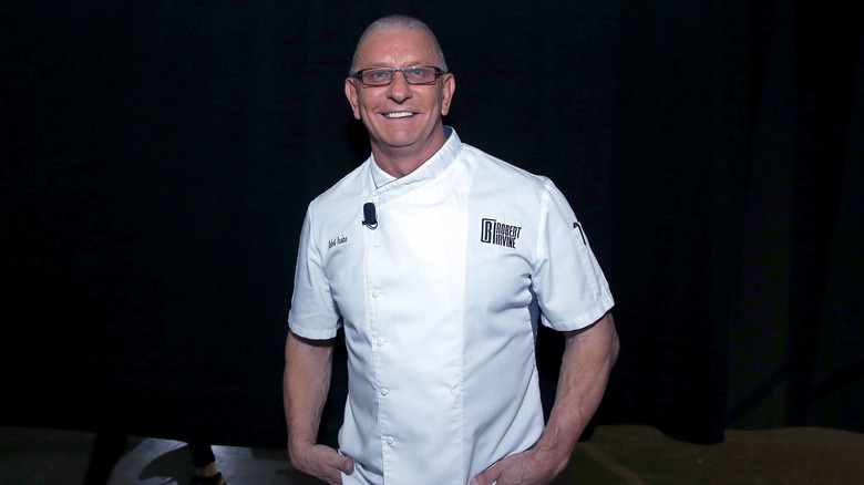 Robert Irvine wears a chef's uniform