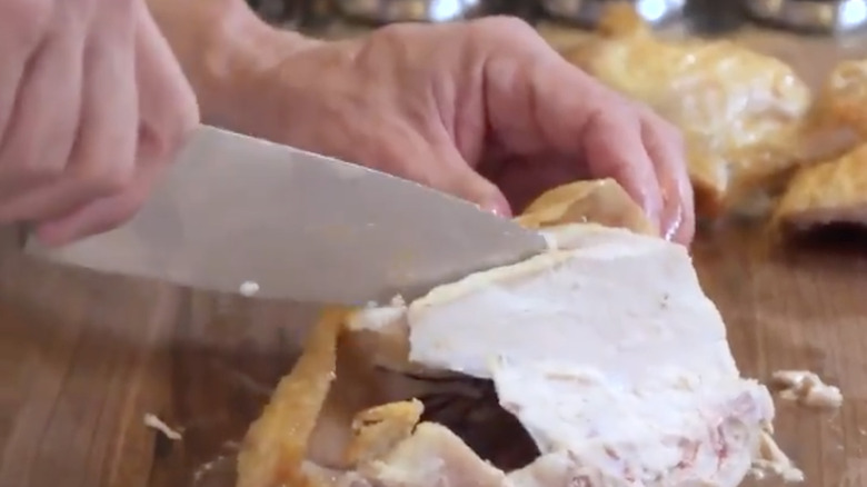 Robert Irvine carving a chicken