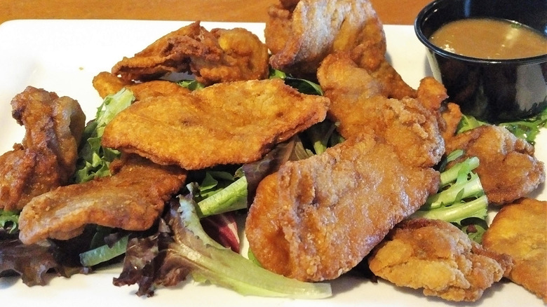 Fried bull testicles over greens