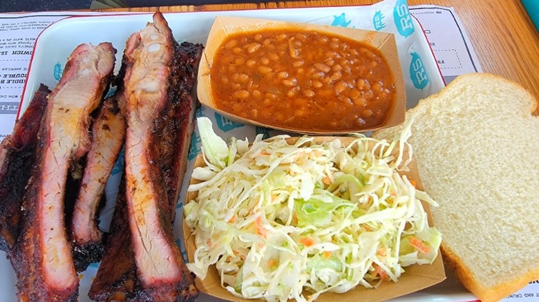 Barbecue ribs with sauce and sides at Rodney Scott's Whole Hog 