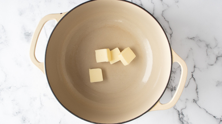 butter cubes in Dutch oven