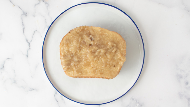 gravy soaked bread slice on plate