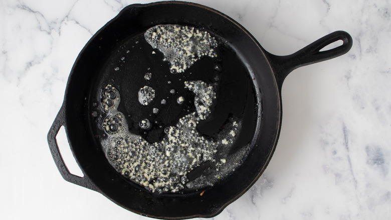 minced garlic sauteeing in butter in skillet