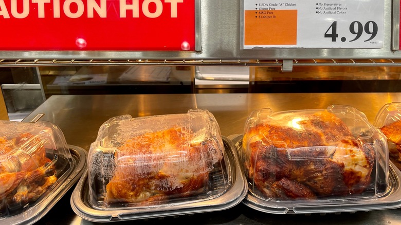 rotisserie chicken in plastic package with red sign