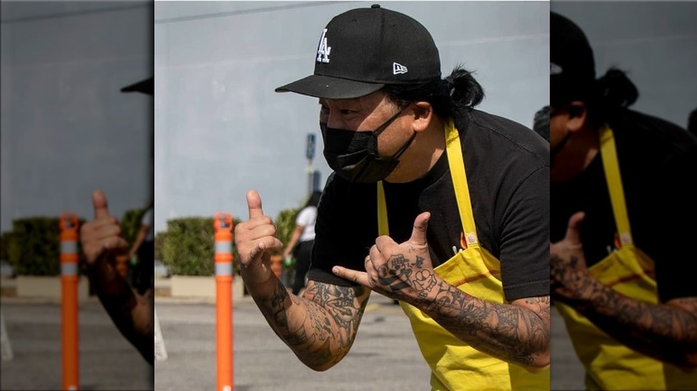 Roy Choi greets people at food giveaway