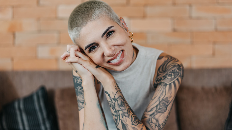 Tattooed person smiling 