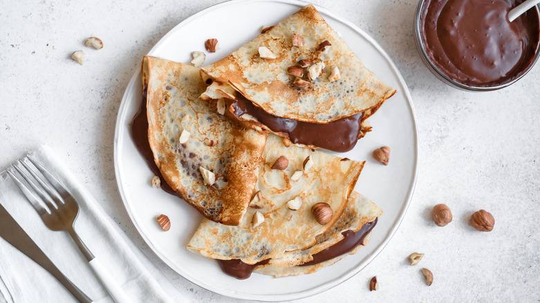 thin French crepes filled with chocolate sauce and topped with hazelnuts