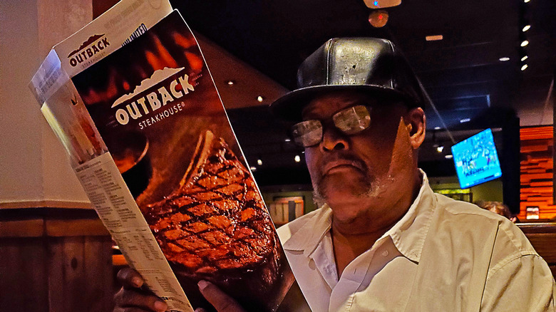 diner holding Outback menu