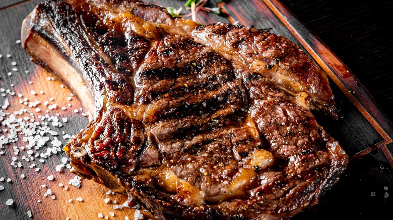 ribeye steak on wooden board