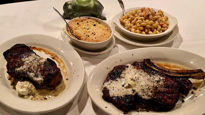 steak and side dishes on table