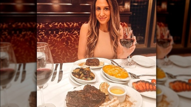 woman holding wine at restaurant