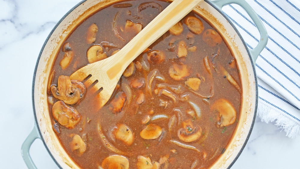 beef gravy and mushrooms cooking for Salisbury steak