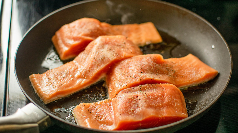 salmon sautéing in skillet