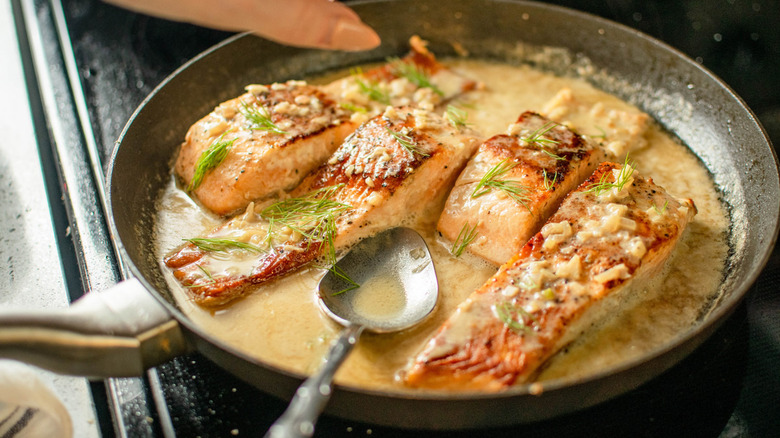 salmon with sauce in skillet