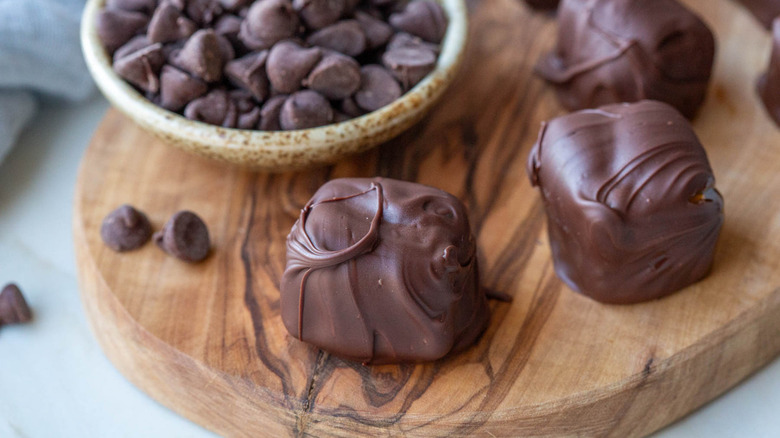 chocolate-coated brie cheese on wooden board