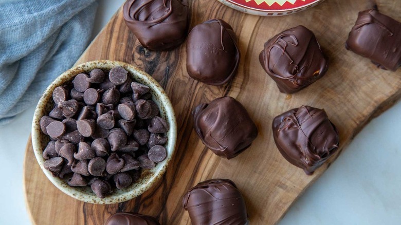 chocolate-coated brie cheese on wooden board