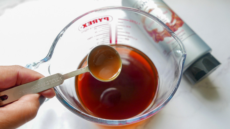 Mixing caramel syrup into coffee