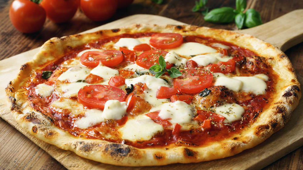 Homemade pizza on wooden board