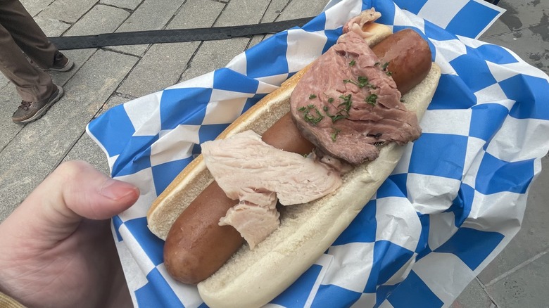 Hot dog topped with prime rib roast and turkey