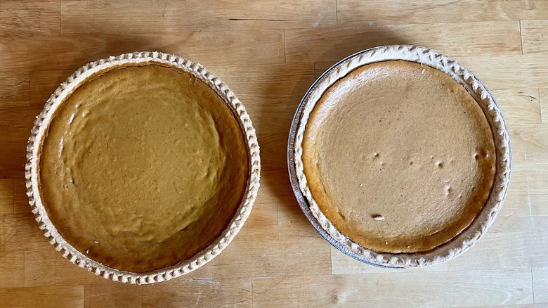 Two pumpkin pies from the side